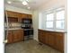 Charming kitchen with stainless steel appliances, wood cabinets and tiled backsplash at 1316 Milstead Ave, Conyers, GA 30012