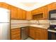 Cozy kitchen featuring stainless steel appliances, wood cabinets, and a tile backsplash at 1316 Milstead Ave, Conyers, GA 30012