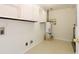 Bright laundry room with tiled floors and ample storage for convenience at 1316 Milstead Ave, Conyers, GA 30012