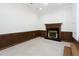 Inviting living room with a fireplace, wood paneling, and a carpet flooring at 1316 Milstead Ave, Conyers, GA 30012