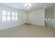 Cozy living room featuring neutral carpet, crown molding, and natural light from a large window at 1316 Milstead Ave, Conyers, GA 30012