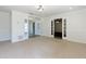 Spacious living room with neutral carpet and light-filled entryway and French doors to other living spaces at 1316 Milstead Ave, Conyers, GA 30012