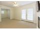 Bright living room with carpet, ceiling fan, and glass paneled doors at 1316 Milstead Ave, Conyers, GA 30012