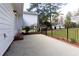 A concrete patio features brick trim, iron fencing, and exterior door access, providing an outdoor living space at 1316 Milstead Ave, Conyers, GA 30012