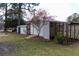 Outdoor shed with wooden lattice and covered area providing ample space for storage or hobby area at 1316 Milstead Ave, Conyers, GA 30012