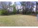 Expansive grassy yard enclosed by a chain-link fence, providing ample space for outdoor activities at 1316 Milstead Ave, Conyers, GA 30012