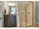 Bathroom featuring a walk-in tiled shower with glass door and vanity with dark countertop at 4820 Marina Ln, Mableton, GA 30126