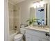 Bathroom featuring a bathtub-shower combo, neutral tile, granite countertop and white vanity at 4820 Marina Ln, Mableton, GA 30126