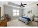 Bedroom featuring a patterned carpet, neutral wall paint, ceiling fan, white blinds and rocking chair at 4820 Marina Ln, Mableton, GA 30126