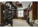 Spacious closet featuring built-in shelving, hanging racks, spiral staircase and a window with bench at 4820 Marina Ln, Mableton, GA 30126