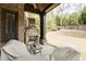 Covered patio with a stone fireplace, ceiling fan, and patio furniture overlooking the yard at 4820 Marina Ln, Mableton, GA 30126