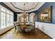 Lovely dining room featuring a stunning chandelier, a large window, and stylish blue walls at 4820 Marina Ln, Mableton, GA 30126