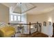 Elegant foyer with hardwood floors, ornate wrought iron railing, tray ceiling and statement chandelier at 4820 Marina Ln, Mableton, GA 30126