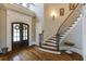 Elegant foyer boasts a curved staircase with a wrought iron banister, and double front doors at 4820 Marina Ln, Mableton, GA 30126