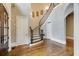 Welcoming foyer with an elegant curved staircase, decorative sconces, and hardwood floors at 4820 Marina Ln, Mableton, GA 30126