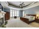 Main bedroom featuring tray ceiling, bay window, fireplace, and ensuite bathroom at 4820 Marina Ln, Mableton, GA 30126