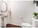 Half-bath with pedestal sink, wood floors, and neutral walls at 1530 Redbud Way, Tucker, GA 30083