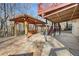 An outdoor patio featuring a wooden pergola, stone and concrete design, perfect for outdoor entertaining at 2070 Sweetgum Trl, Cumming, GA 30041