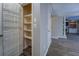 Finished basement hallway with a storage door and open doorway leading to a fireplace at 2070 Sweetgum Trl, Cumming, GA 30041