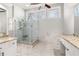 Bathroom featuring glass shower with seat, granite countertops, tile floors, and natural light at 2070 Sweetgum Trl, Cumming, GA 30041