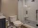 Modern tiled bathroom features a shower with glass door, a toilet, and vanity with a marble countertop at 2070 Sweetgum Trl, Cumming, GA 30041