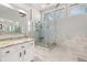 Bathroom featuring glass shower with seat, granite countertops, tile floors, and natural light at 2070 Sweetgum Trl, Cumming, GA 30041