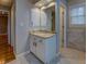 Bathroom vanity featuring a granite countertop, white cabinets, and ample lighting at 2070 Sweetgum Trl, Cumming, GA 30041