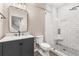 Bathroom with white tiled shower, dark gray vanity, and marble countertop at 2070 Sweetgum Trl, Cumming, GA 30041