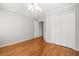 Bright bedroom with wood floors, ceiling fan, and white closet doors at 2070 Sweetgum Trl, Cumming, GA 30041