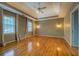 Large bedroom with wood floors, tray ceiling, and natural lighting at 2070 Sweetgum Trl, Cumming, GA 30041