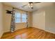 Bedroom with hardwood floors, natural light, and double door closet at 2070 Sweetgum Trl, Cumming, GA 30041