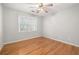 Bedroom with hardwood floors, ceiling fan, and a window with natural light at 2070 Sweetgum Trl, Cumming, GA 30041