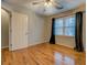 Cozy bedroom with hardwood flooring and a window with natural light at 2070 Sweetgum Trl, Cumming, GA 30041