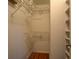 Walk-in closet with custom shelving and hanging rods for optimal storage at 2070 Sweetgum Trl, Cumming, GA 30041