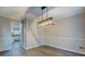 Dining area featuring chair rail detail, modern light fixture, and an opening into the kitchen at 2070 Sweetgum Trl, Cumming, GA 30041