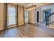 Dining area with modern light fixture, neutral walls, luxury vinyl flooring, and large windows with curtains at 2070 Sweetgum Trl, Cumming, GA 30041