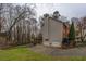 Exterior view of a home with a backyard, wooden pavilion, and two-car garage at 2070 Sweetgum Trl, Cumming, GA 30041