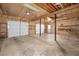 Spacious garage with two large doors, shelving, and concrete floors at 2070 Sweetgum Trl, Cumming, GA 30041