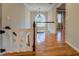 Upstairs hallway with hardwood floors, decorative railing, and a view to the front entry at 2070 Sweetgum Trl, Cumming, GA 30041