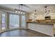 Open kitchen and dining area showcasing granite countertops and modern lighting at 2070 Sweetgum Trl, Cumming, GA 30041