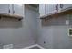 Well-lit laundry room featuring white cabinets and modern gray walls at 2070 Sweetgum Trl, Cumming, GA 30041