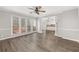 Spacious living room with access to a deck, showcasing neutral walls and flooring, and an open doorway to the kitchen at 2070 Sweetgum Trl, Cumming, GA 30041