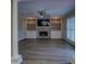 Inviting living room featuring a fireplace with built-in shelving and a ceiling fan at 2070 Sweetgum Trl, Cumming, GA 30041