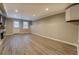 Spacious living room featuring recessed lights, a door to the outside, and wood floors at 2070 Sweetgum Trl, Cumming, GA 30041