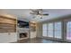 Cozy living room showcasing a stone fireplace, built-in shelving, and access to the deck at 2070 Sweetgum Trl, Cumming, GA 30041