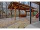 Outdoor living space features a covered pavilion, concrete deck, and stone pathway at 2070 Sweetgum Trl, Cumming, GA 30041