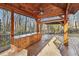 Wooden pergola with a built-in outdoor kitchen area, complete with counter space and storage, perfect for entertaining at 2070 Sweetgum Trl, Cumming, GA 30041