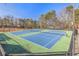 Well-maintained tennis courts surrounded by mature trees, provide a perfect setting for recreational play at 2070 Sweetgum Trl, Cumming, GA 30041