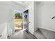 A well-lit entryway with gray hardwood flooring, an open front door and carpeted stairs at 217 Enterprise Path, Hiram, GA 30141