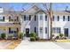 Two-story townhouse features a concrete driveway and trimmed bushes in front of the home at 217 Enterprise Path, Hiram, GA 30141